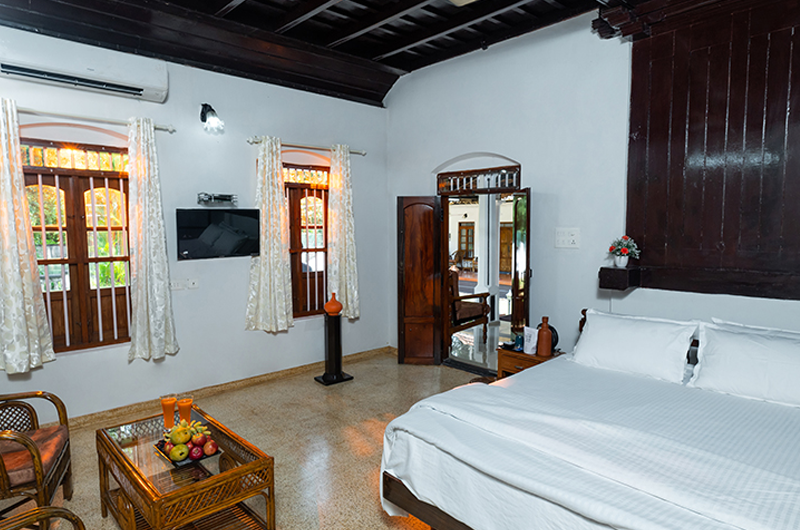 Bedroom view of Babira Brookside Heritage Resort Kumarakom with cozy traditional interiors