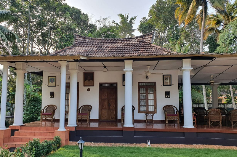 Front view of Babira Brookside Heritage Resort Kumarakom surrounded by lush greenery