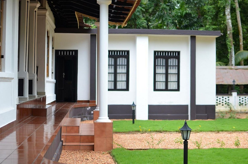 Heritage veranda view of Babira Brookside Resort Kumarakom overlooking green surroundings
