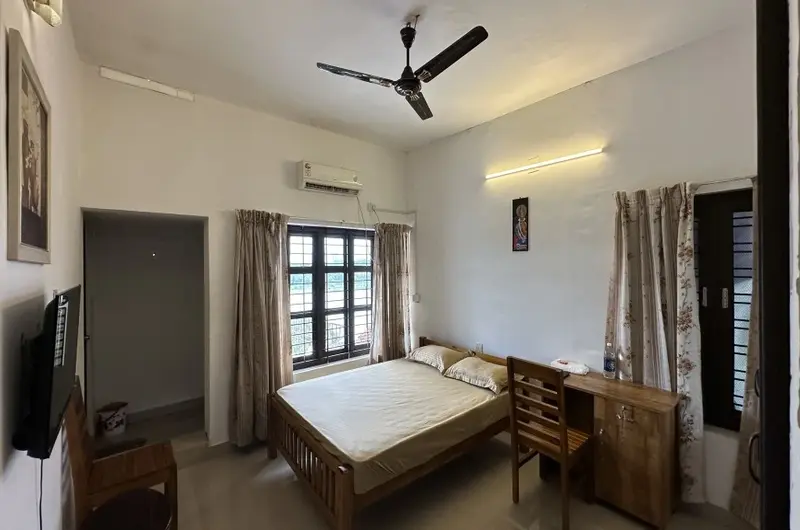 Elegant traditional bedroom at Lakshmipuram Palace Heritage Homestay